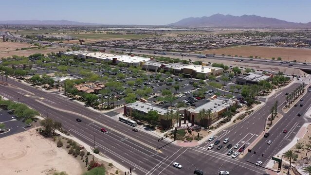 Afternoon aerial view of new shopping mall sprawl and empty lots of downtown Goodyear, Arizona, USA.
