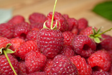 Ripe red raspberry is on the table