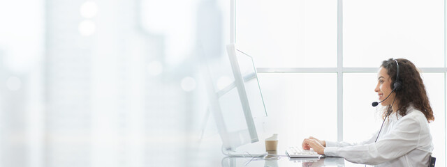 Female call center with headset service support customer by computer. Technical support operator...