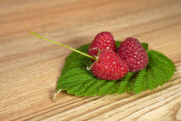 Ripe red raspberry is on the table