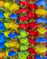 Fototapeta na wymiar Close up of blue, yellow, and red cloth flowers.
