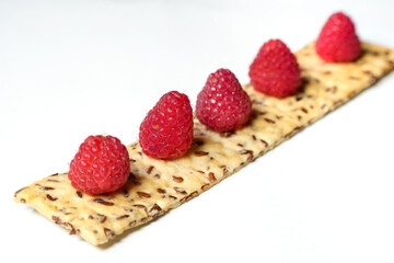 Ripe red raspberry is on the table
