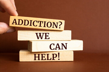 Wooden blocks with words 'Addiction? We can help'.