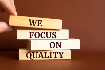 Wooden blocks with words 'We focus on quality'. Business concept