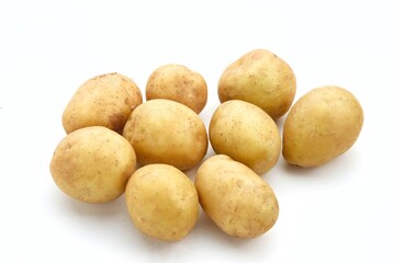 A pile of fresh organic baby potatoes, on white background. 

