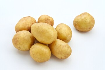 A pile of fresh organic baby potatoes, on white background. 
