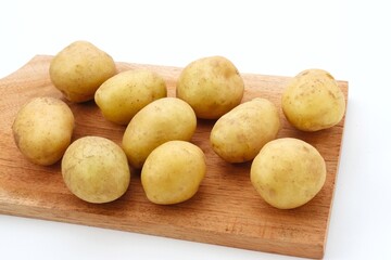 A pile of fresh organic baby potatoes, on white background. 
