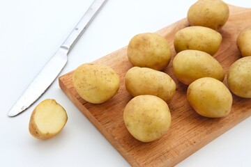 A pile of fresh organic baby potatoes, on white background. 
