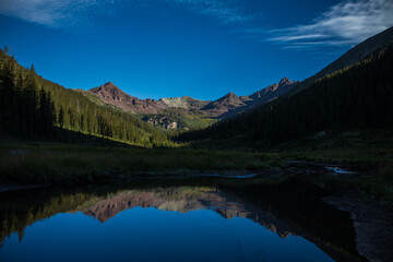 Fototapeta na wymiar Mountain reflection in alpine valley pond