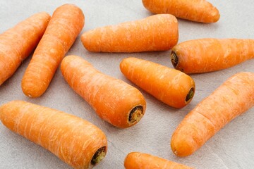 Fresh organic carrots on grey background.
