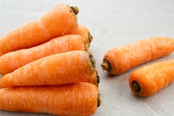 Fresh organic carrots on grey background.
