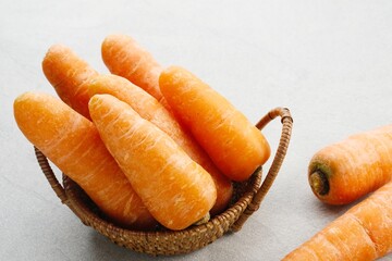 Fresh organic carrots on grey background.
