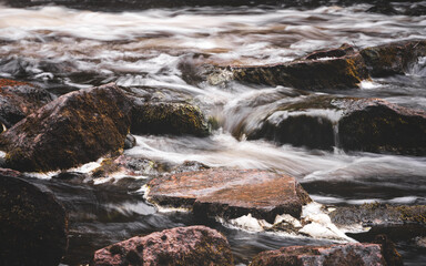 A Fast River Flowing Over Rocks