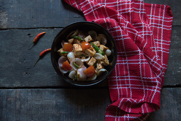 Paneer or cottage cheese cubes saute with veggies in a bowl. Top view, selective focus.