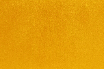 Gold or yellow paint on cement wall texture  background.