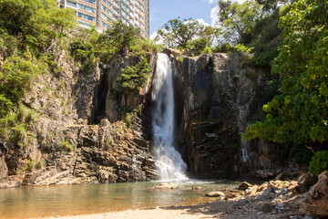 Fototapeta na wymiar 2022 Aug 10,Hong Kong.Waterfall Bay in Pok Fu Lam, Hong Kong Island, Hong Kong.One of the Waterfall close to the city.