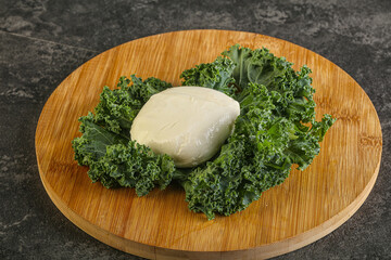 Soft mozzarella cheese over board