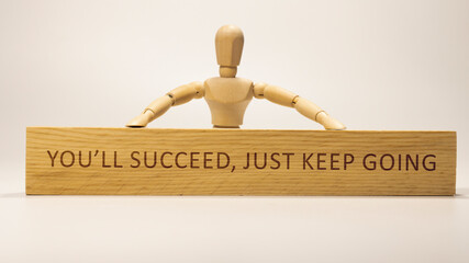 You'll succeed, just keep going. written on wooden surface. Personal development and education