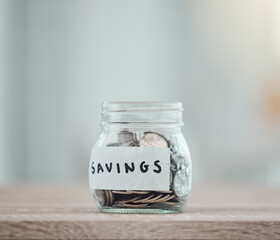 Savings, money and finance with many silver coins in a jar for retirement, banking and investment...