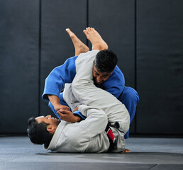 . Men fighting during karate training at fitness studio, doing fight club workout at gym and...