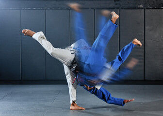 Fitness, strength and men in a karate fight in a gym for martial arts exercise. Action, motion and...