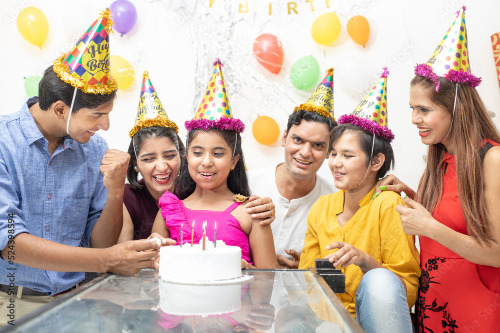 Wall mural Happy Indian asian family or friends celebrate birthday. Eat cake, holidays and people concept.