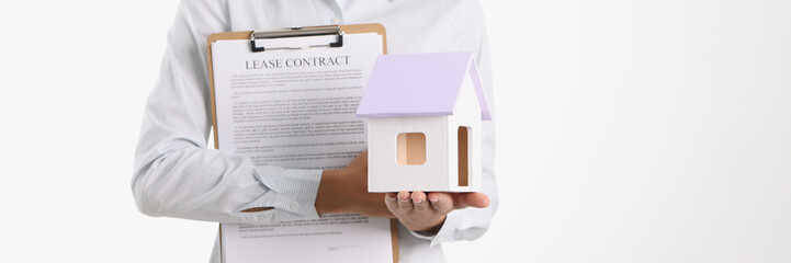 Fototapeta na wymiar Realtor agent holding house and lease contract closeup