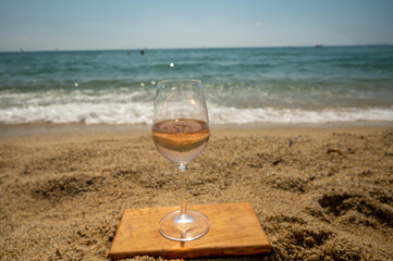 Cold rose wine from Provence served outdoor on white sandy beach Plage de Pampelonne near Saint-Tropez, France