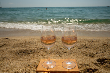 Cold rose wine from Provence served outdoor on white sandy beach Plage de Pampelonne near Saint-Tropez, France