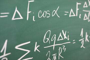 Formulas written by chalk on chalkboard