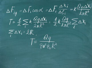 Equations written in chalk on chalkboard