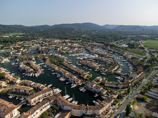 Aerial view on Gulf of Saint-Tropez, sail boats, houses of Port Grimaud and Port Cogolin, summer vacation in Provence, France