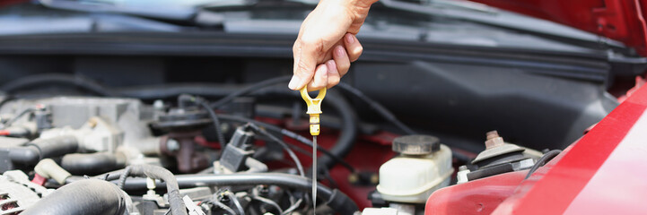 Dipstick for checking oil level in car engine closeup