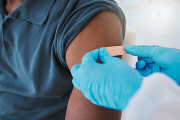 Corona, compliance and the vaccine being given to man by a health care worker. Closeup of a nurse putting a plaster on a man after an injection or treatment. Male making decision to get booster shot - obrazy, fototapety, plakaty
