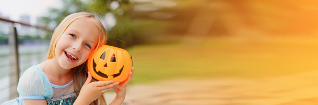 Lifestyle portrait of Happy caucasian girl with blonde hair in blue dress celebrating Halloween