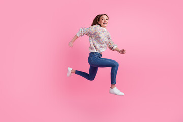 Full length profile side photo of active lady jump high run fast race isolated on pastel pink color background