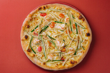 Thin-crust pizza dough with shrimps and zucchini
