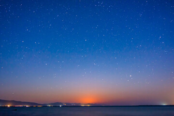Fototapeta na wymiar Lake and night sky with bright stars
