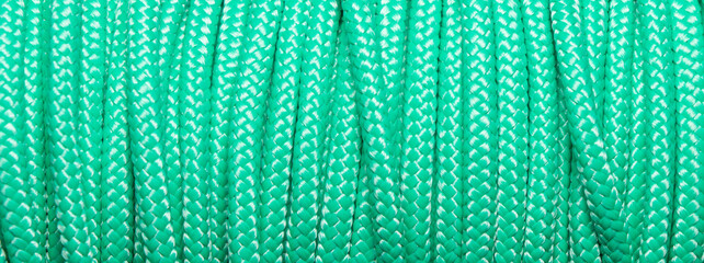 Static light green colored rope for climbing and mountaineering as a pattern