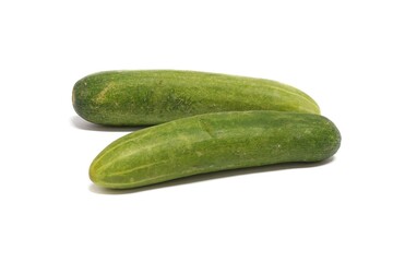 photo of two cucumbers on the white floor