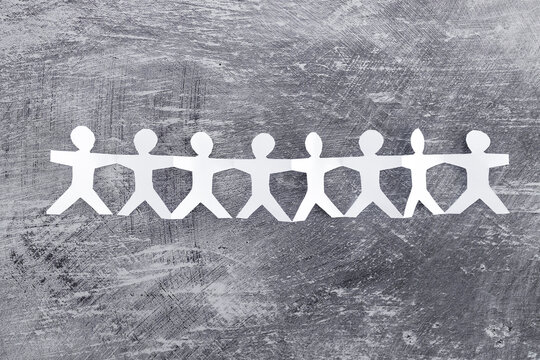 manpower and teamwork, paper people chain with text on gray background