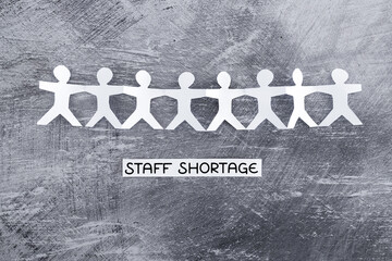 staff shortages and business struggling after the pandemic, peper people chain with text on gray...