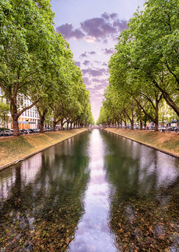 Konigsallee - a popular tourist and historical attraction of the city of Dusseldorf in Germany. A canal planted with plane trees with fashionable shopping galleries