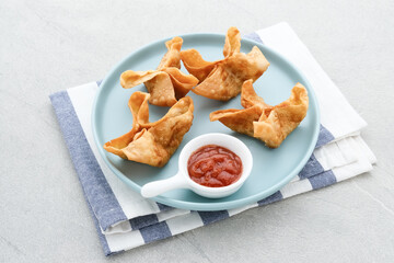 Pangsit, Pangsit Goreng, Delicious Pangsit Ayam Goreng (Chicken Fried Dumpling), Indonesian Traditional Food made from flour and chicken. Served with sauce