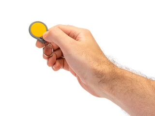 Man hand hold and apply colored key fob contactless authentication NFС and RFID. Isolated on white background.