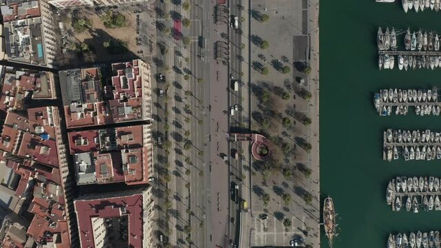 Top down shot of waterfront with Moll de Bosch i Alsina pedestrian zone in Port Vell in centre city. Barcelona, Spain