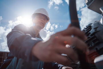 Technicians are checking the operation of the solar power plant equipment so that the power generation can operate at full capacity. Alternative energy to conserve the world's energy