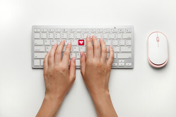 Female hands with keyboard and mouse on white background, top view. Online dating concept