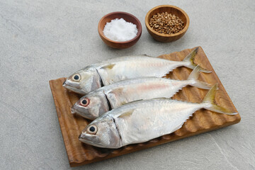 Ikan Kembung, Kembung Fish or Mackerel Fish on wooden chopping board.
