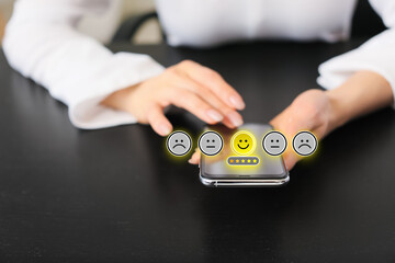 Woman giving high rating to new mobile application at table, closeup